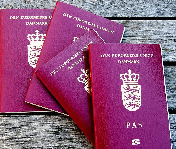 Four Danish Passports. Red European Community Passports. - DokumentenBeratung